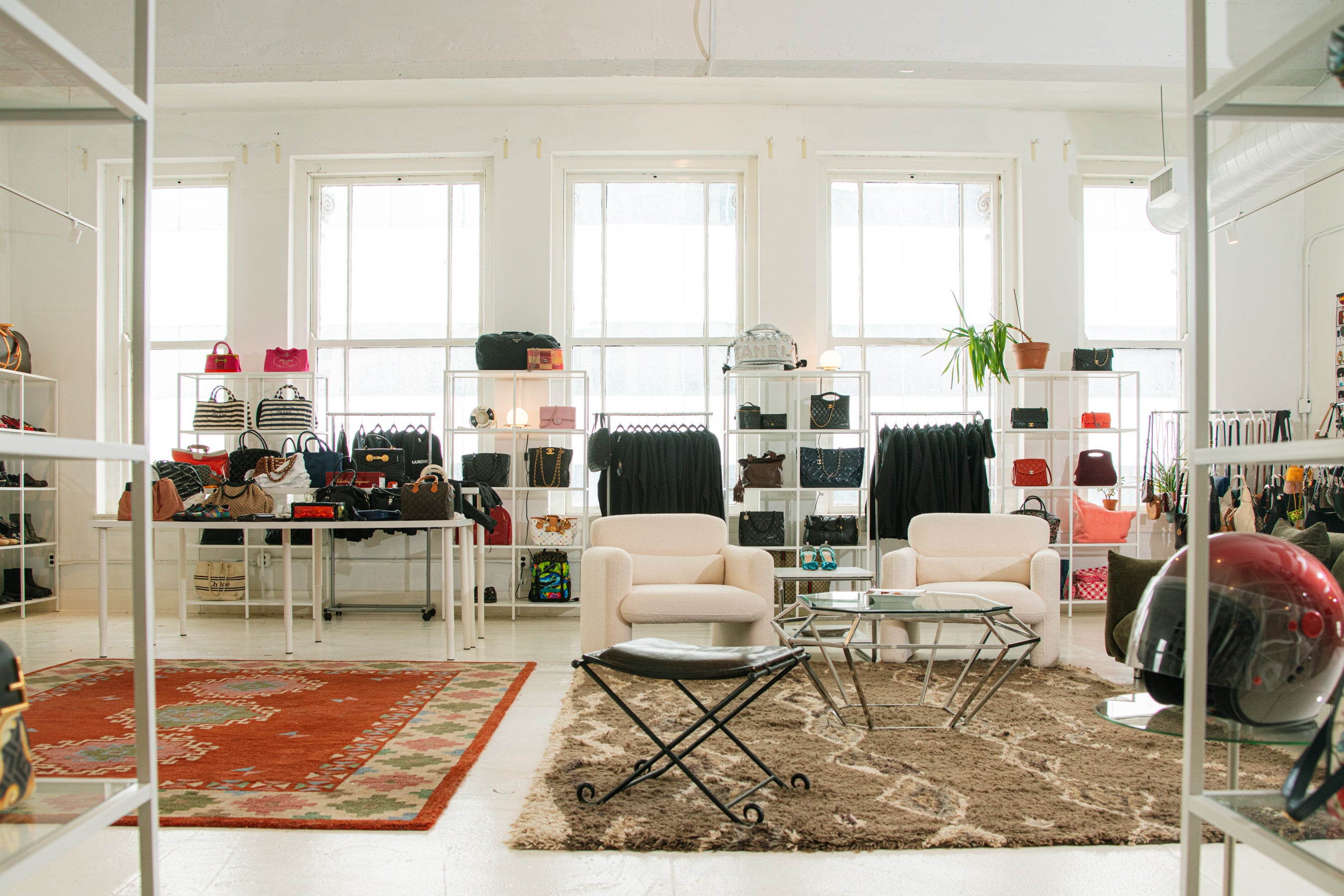 AARCHIVE showroom seating area with designer bags and apparel