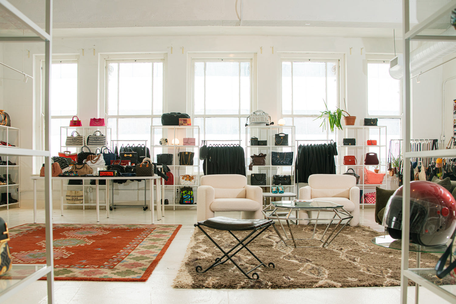 AARCHIVE showroom seating area with designer bags and apparel